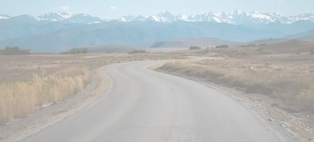 Open road leading to the mountains, background image for Marked by Memory website