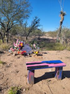 Roadside memorial for Donna Labor in Vail, Arizona, featuring a white cross and a purple memorial bench.