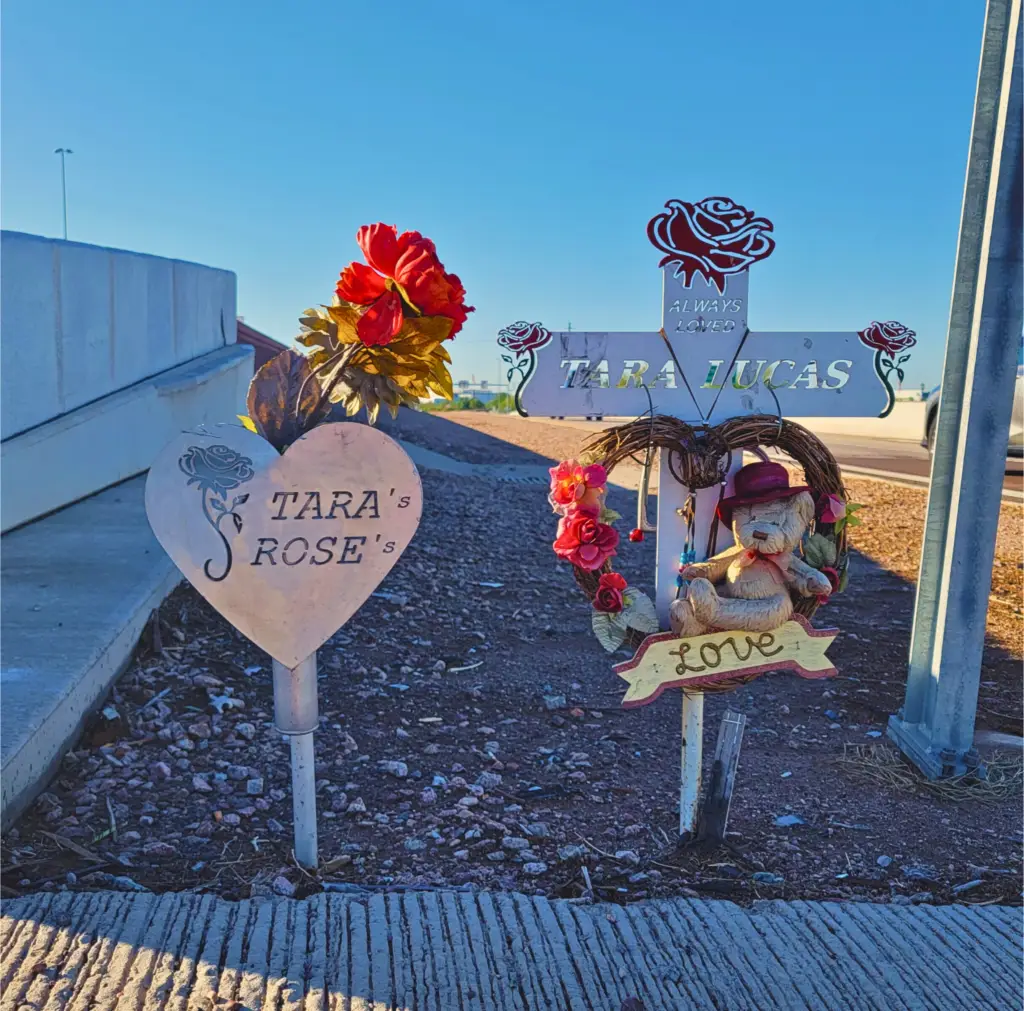 A roadside memorial for Tara Lucas, featuring a personalized marker with her name and commemorative details in an Arizona landscape.
